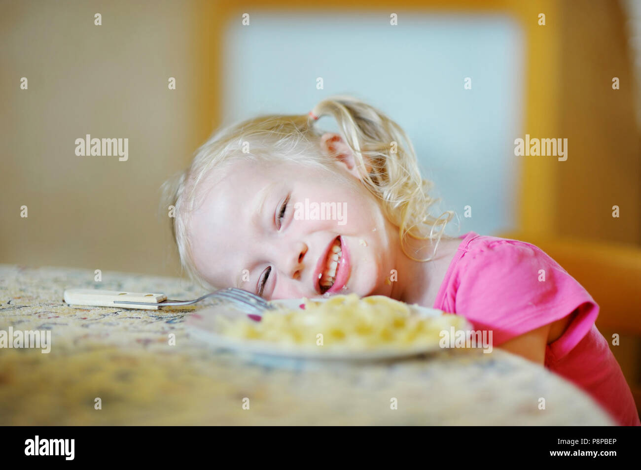Cute funny little girl eating spaghetti Stock Photo - Alamy