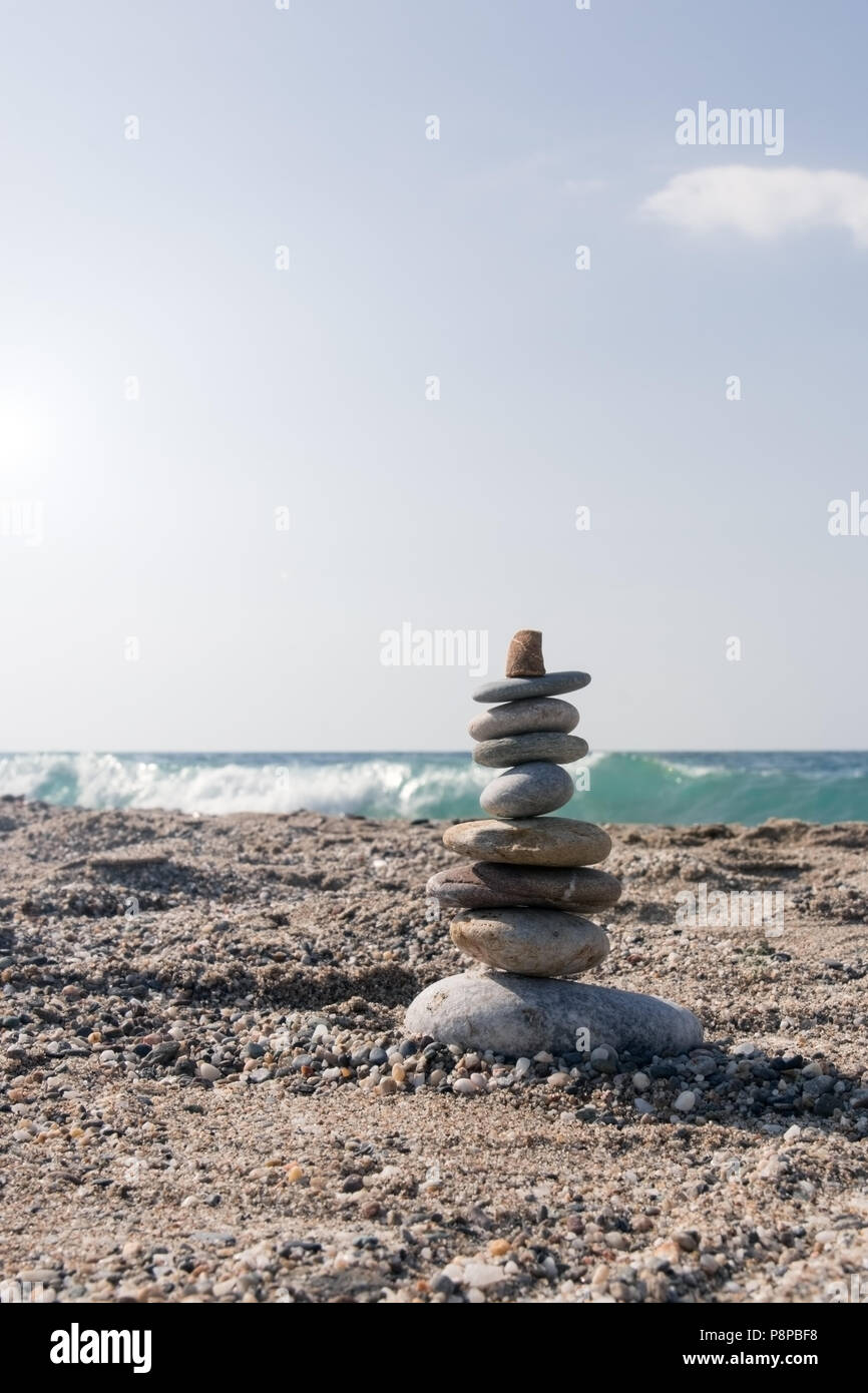 Nine pieces of stone in balance at the agitated seaside Stock Photo