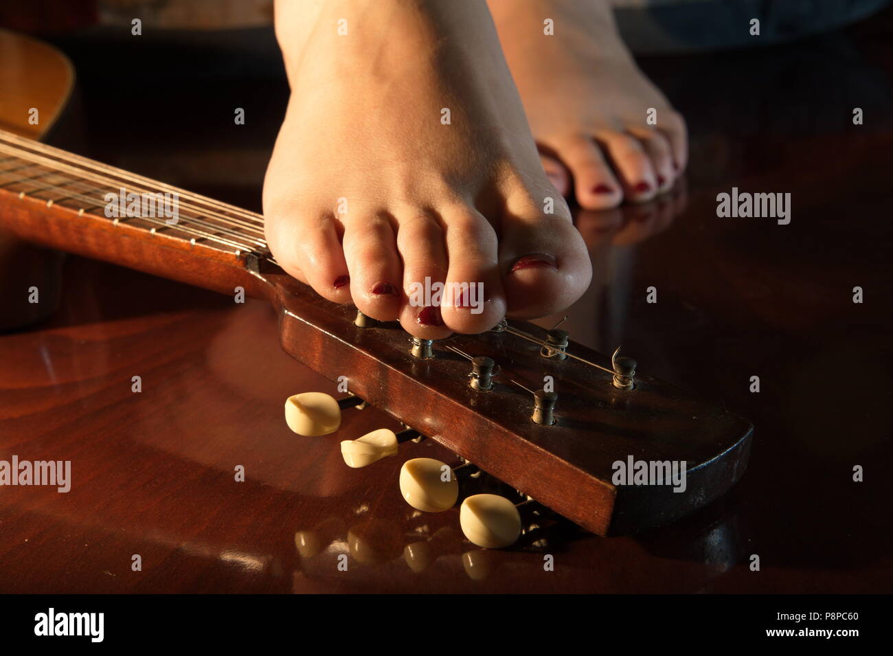 lady foot on mandolina Stock Photo