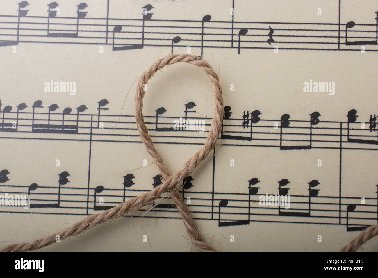linen thread is placed on paper with musical notes Stock Photo - Alamy