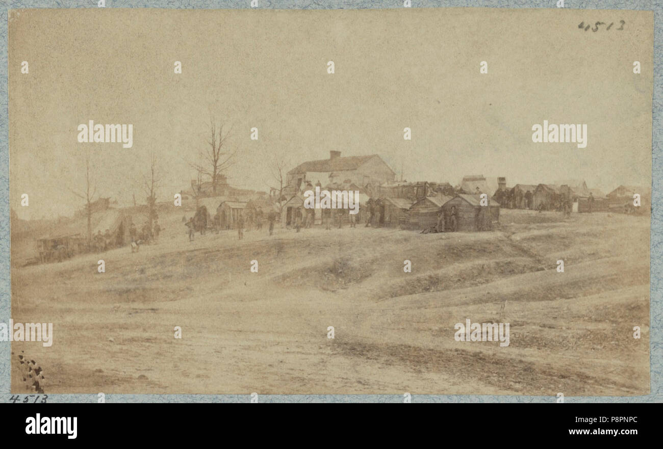 A Camp Made Up Of Small Cabins That Surround A Large Building