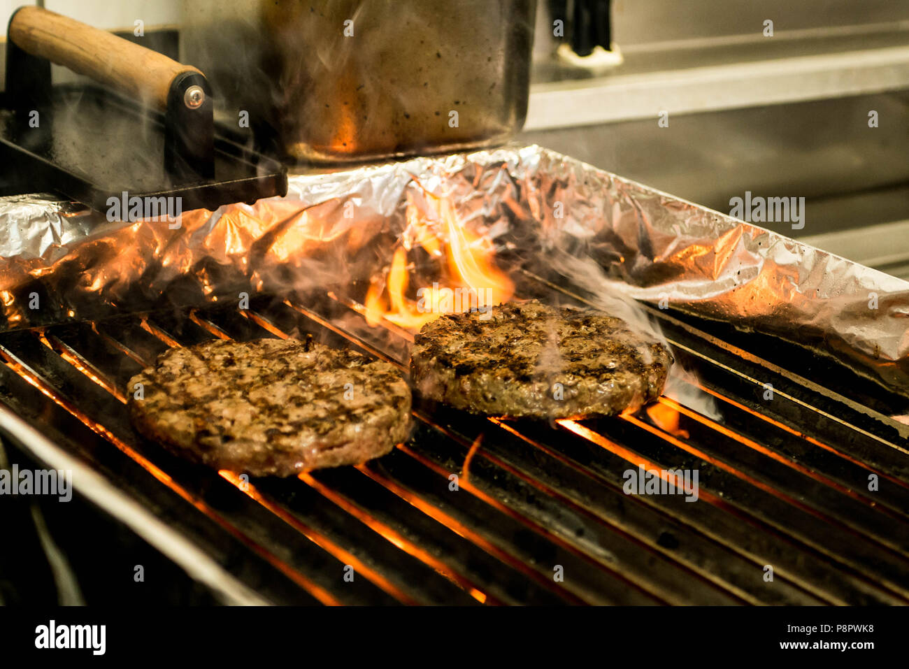 hamburger beef patty - grilled meat and cheese on a barbecue grill fire ...