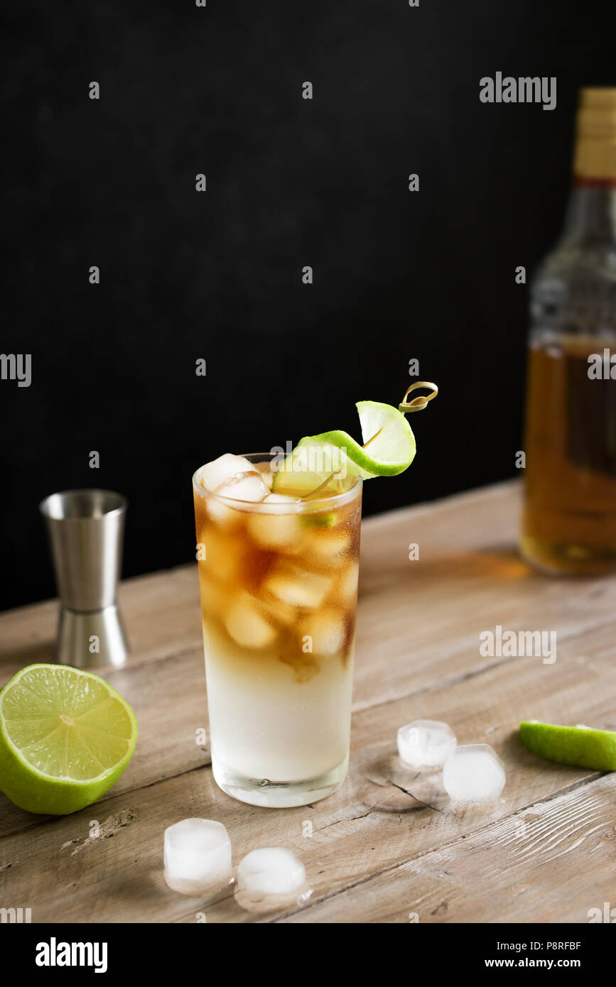 Dark and Stormy Rum Cocktail with Ginger Beer and Lime garnish. Glass of Dark and Stormy