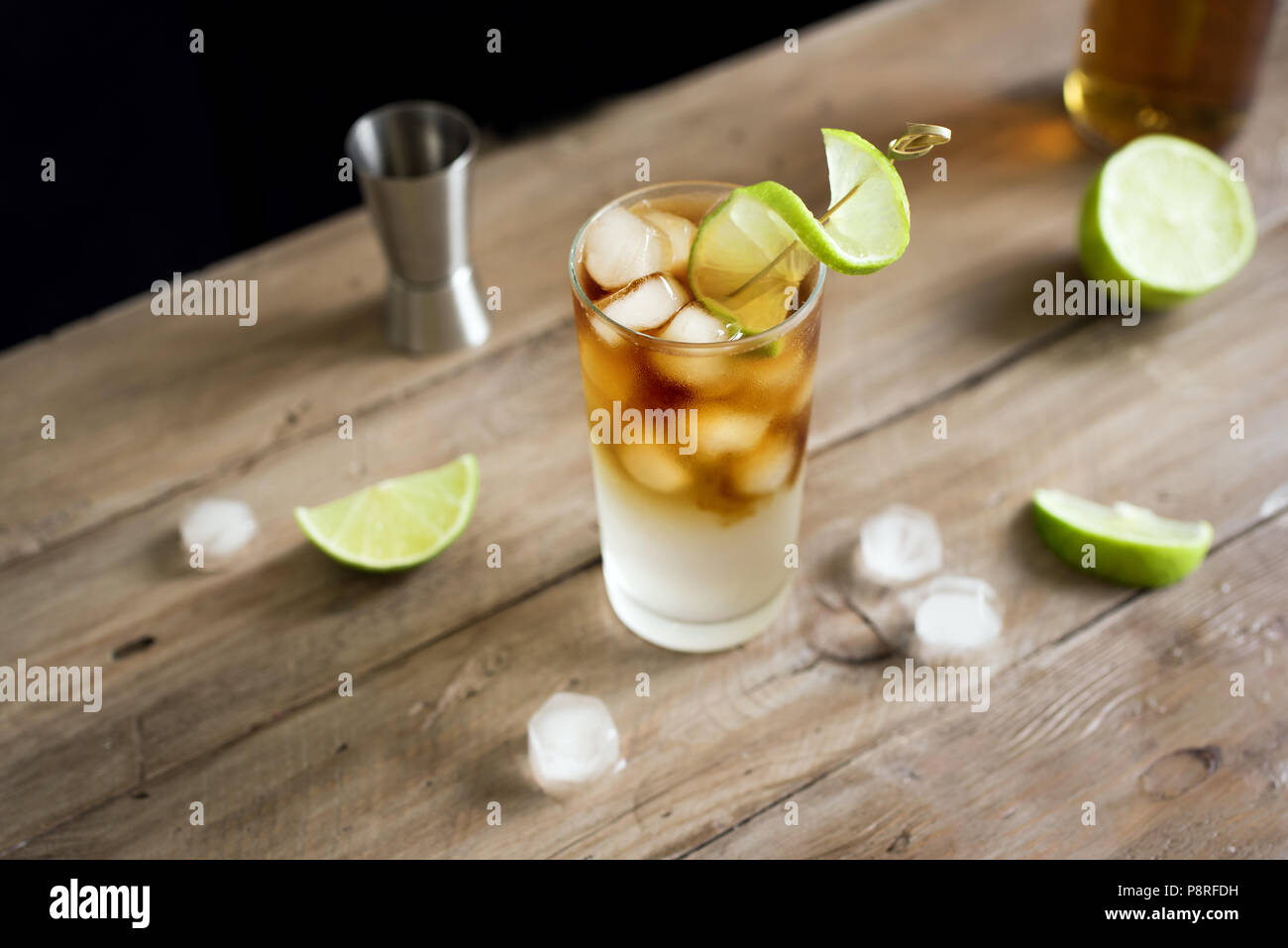 Dark and Stormy Rum Cocktail with Ginger Beer and Lime garnish. Glass ...