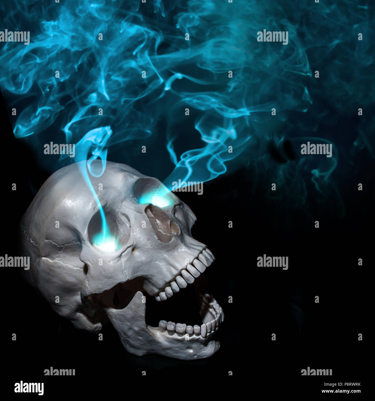 Halloween. Dead man and magic. Screaming human skull with eye smoke. Black background, Halloween concept, free space Stock Photo
