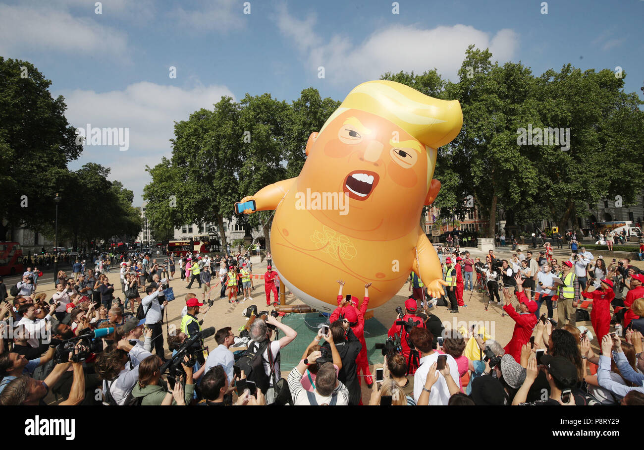 A 'Baby Trump' balloon rises after being inflated in London's Parliament Square, as part of the protests against the visit of US President Donald Trump to the UK. Stock Photo