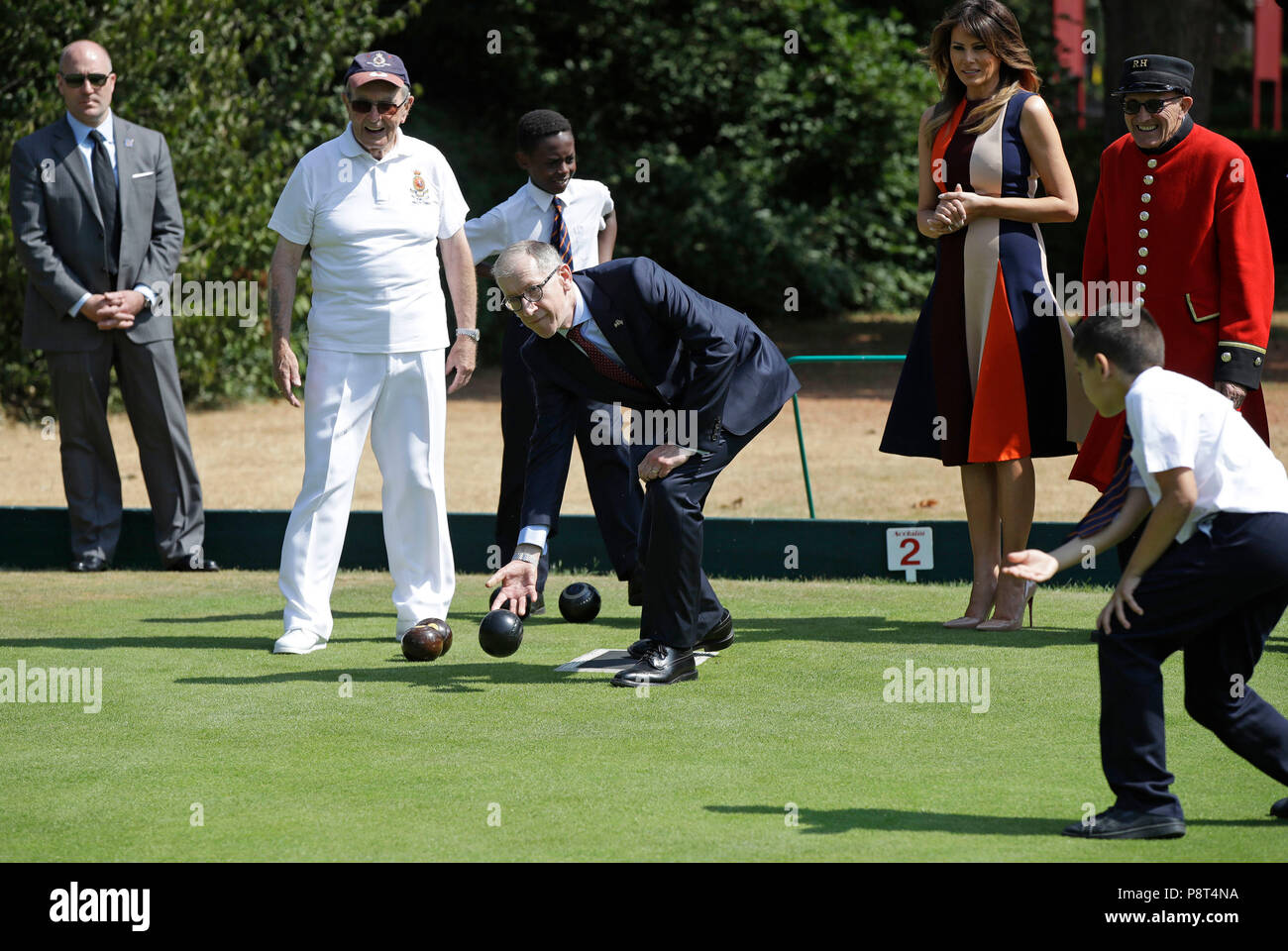 A school boy instructs Philip May the husband of Prime Minister Theresa May, in the art of bowls as he is watched by US First Lady Melania Trump, during her visit to the Royal Hospital, Chelsea, London. Stock Photo