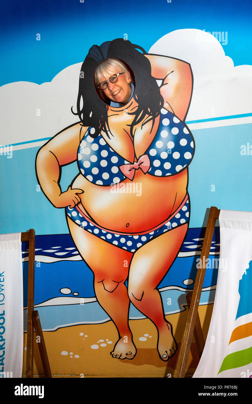 UK, England, Lancashire, Blackpool, Blackpool Tower, senior tourist posing in bathing belle cutout Stock Photo