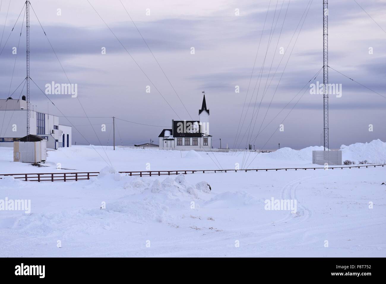 The small church of Vardø behind wires of antennas in the snow of the Nothern Europe winter, 8 March 2017 | usage worldwide Stock Photo