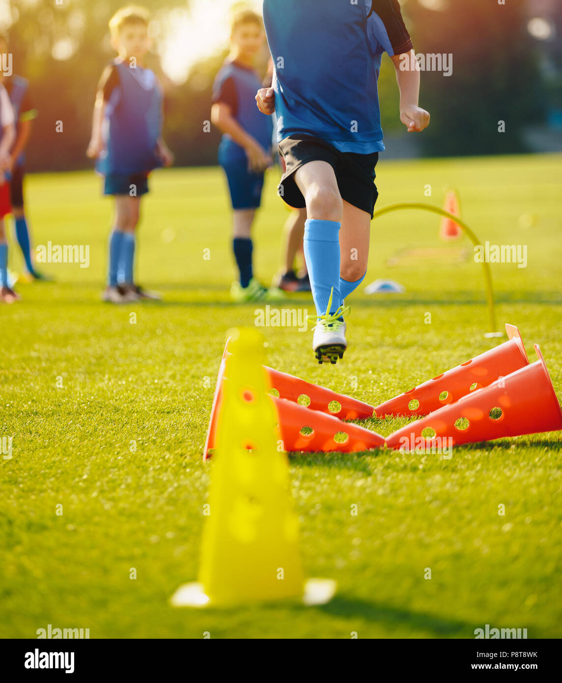 Kid Young Athletes Training with Football Equipment. Football Speed