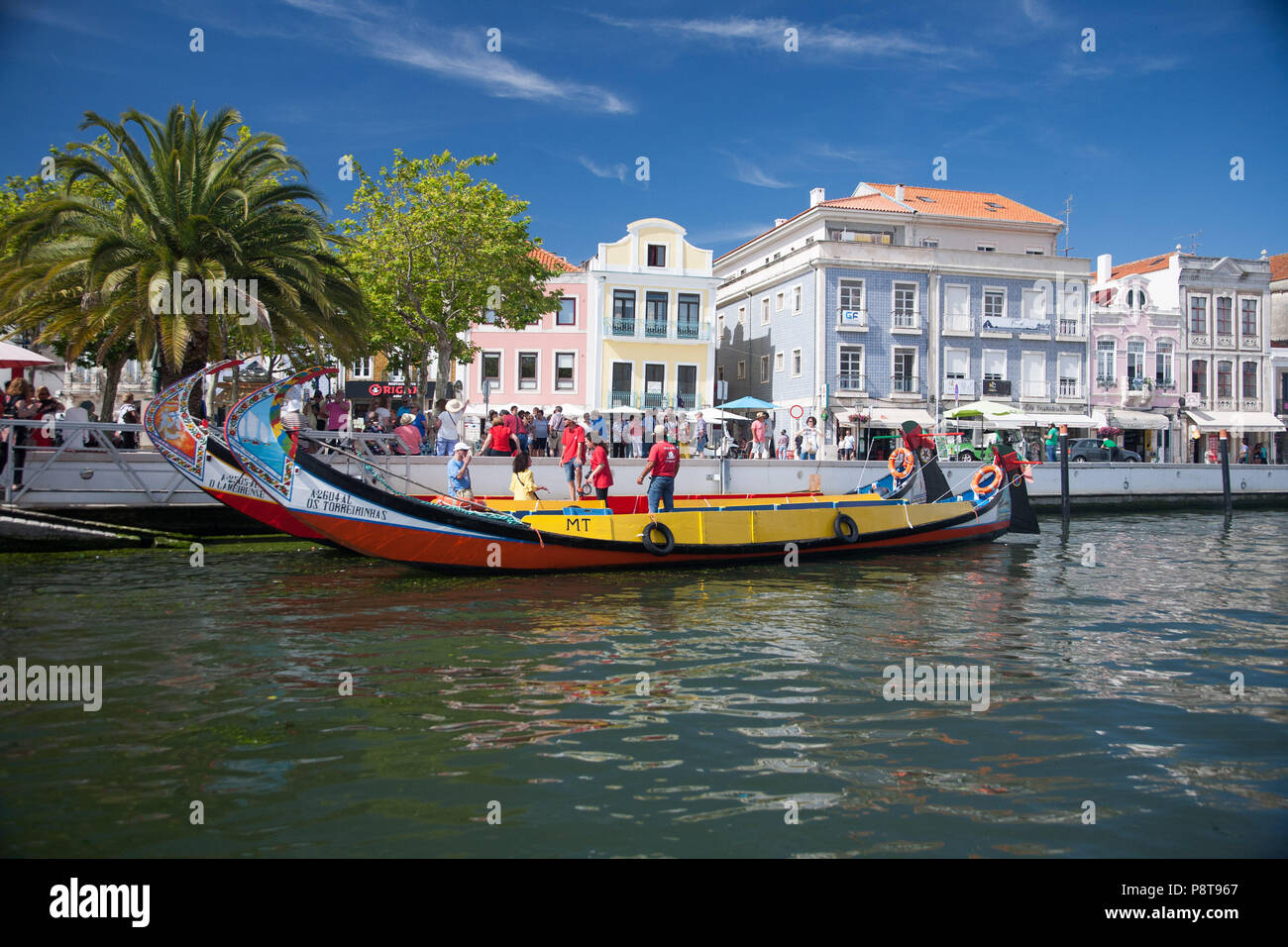 A Moliceiro (a boat formerly used for collecting seaweed) taking aboard visitors to see the canals of Aveiro, Portugal Stock Photo