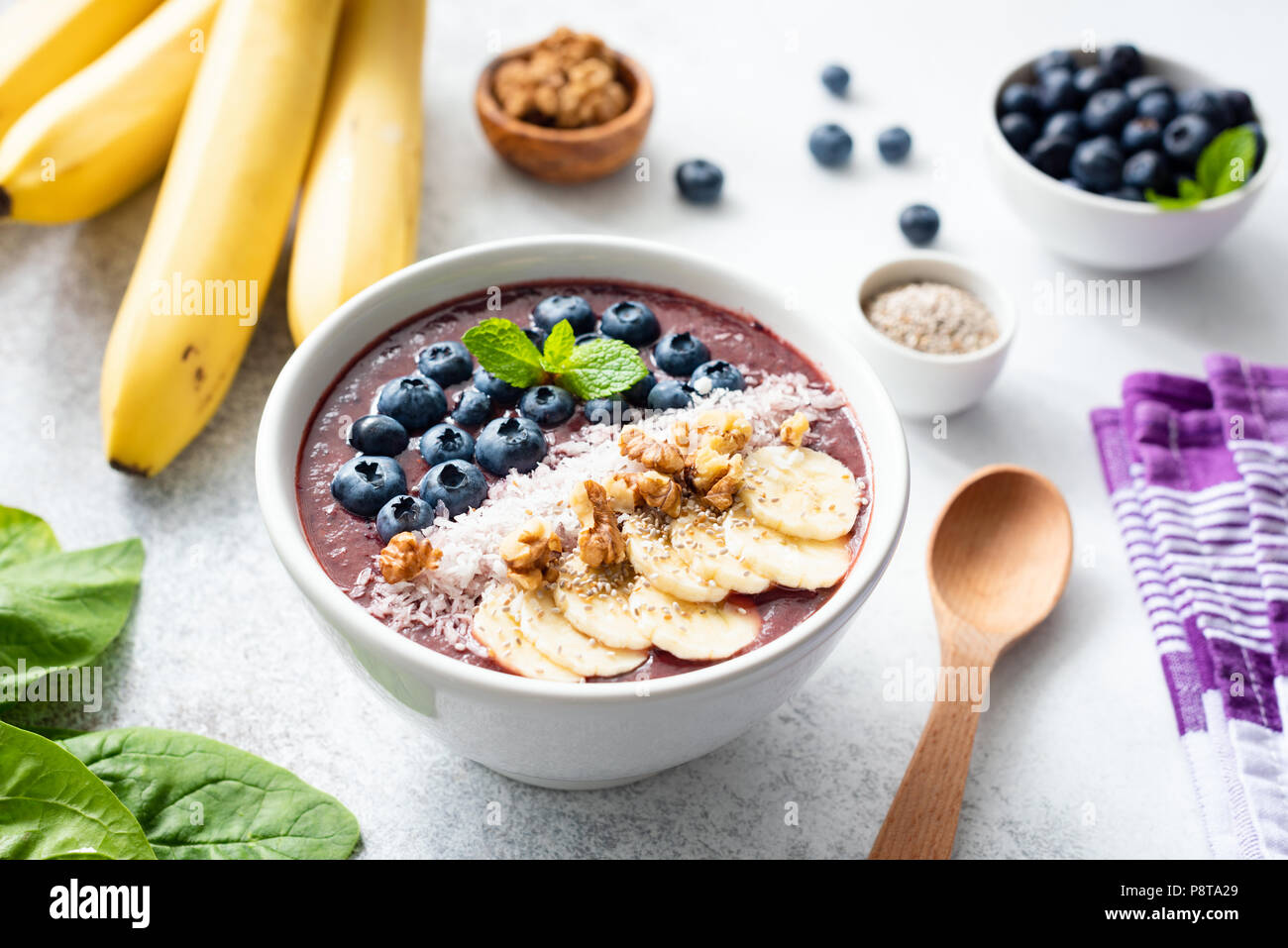 Acai smoothie bowl topped with banana, chia seed, blueberries, walnuts and coconut. Concept of healthy eating, healthy lifestyle, dieting, detox and v Stock Photo