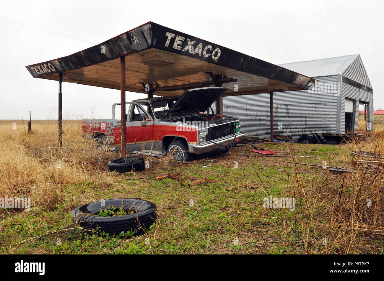 An abandoned Texaco gas station canopy covers an old pickup truck in the Route 66 town of Conway, Texas. The Panhandle town lies east of Amarillo. Stock Photo