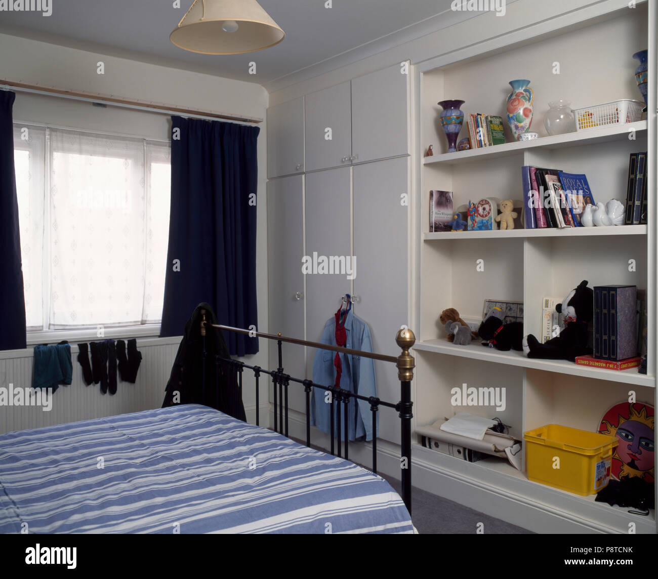 White Bedroom With Built In Wardrobe And Shelving Unit Stock Photo