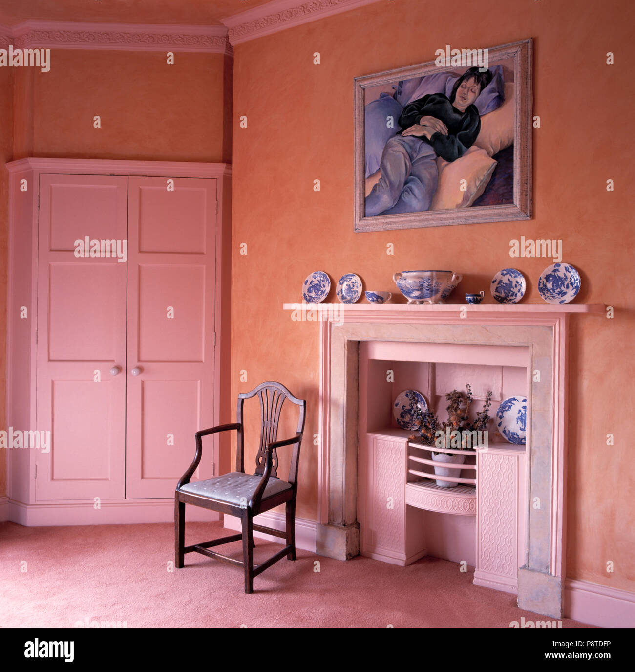Painting Above Fireplace In Pink Bedroom With Pale Pink Fitted