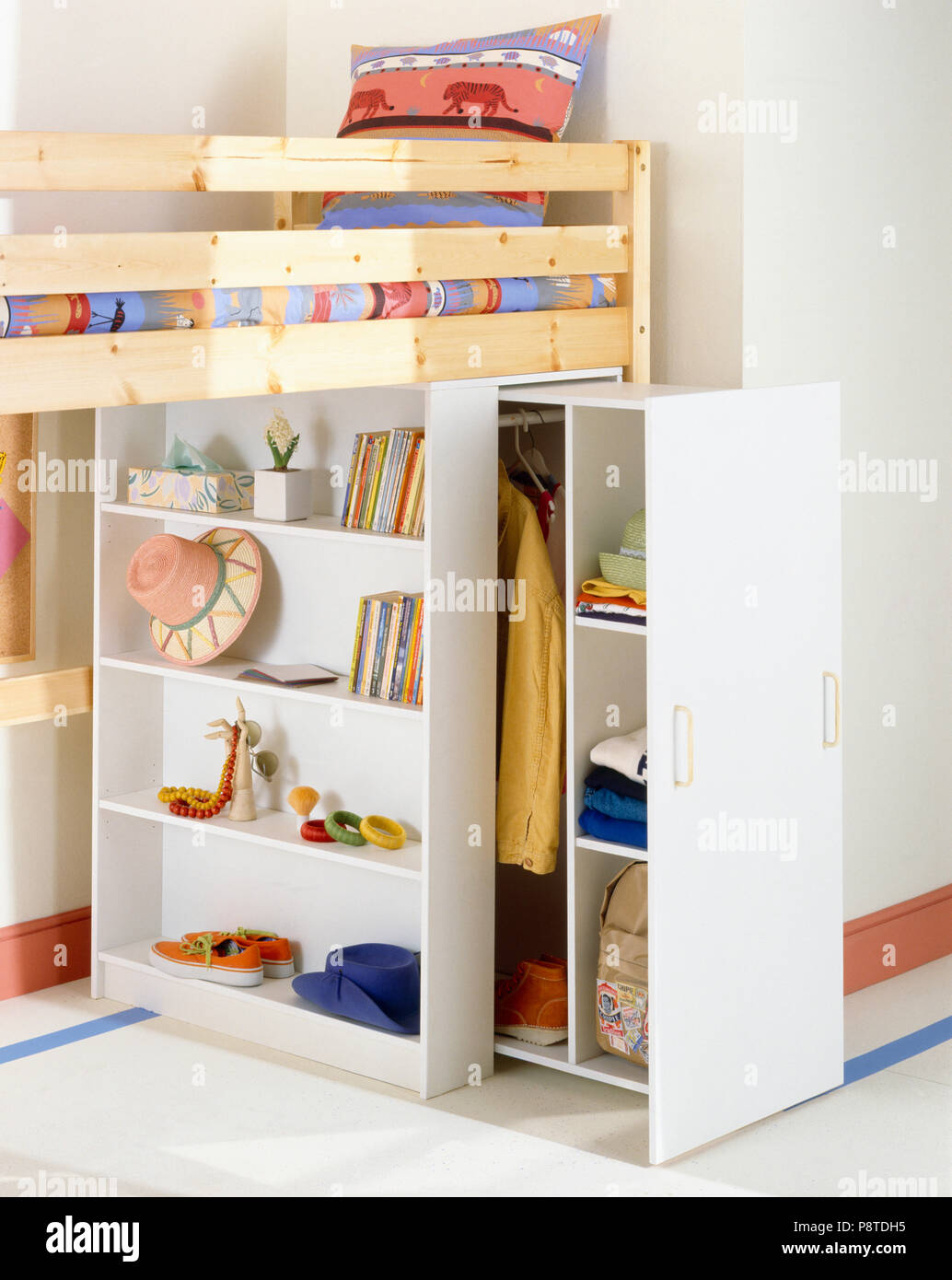 Shelving and pullout clothes storage below platform bed in child's