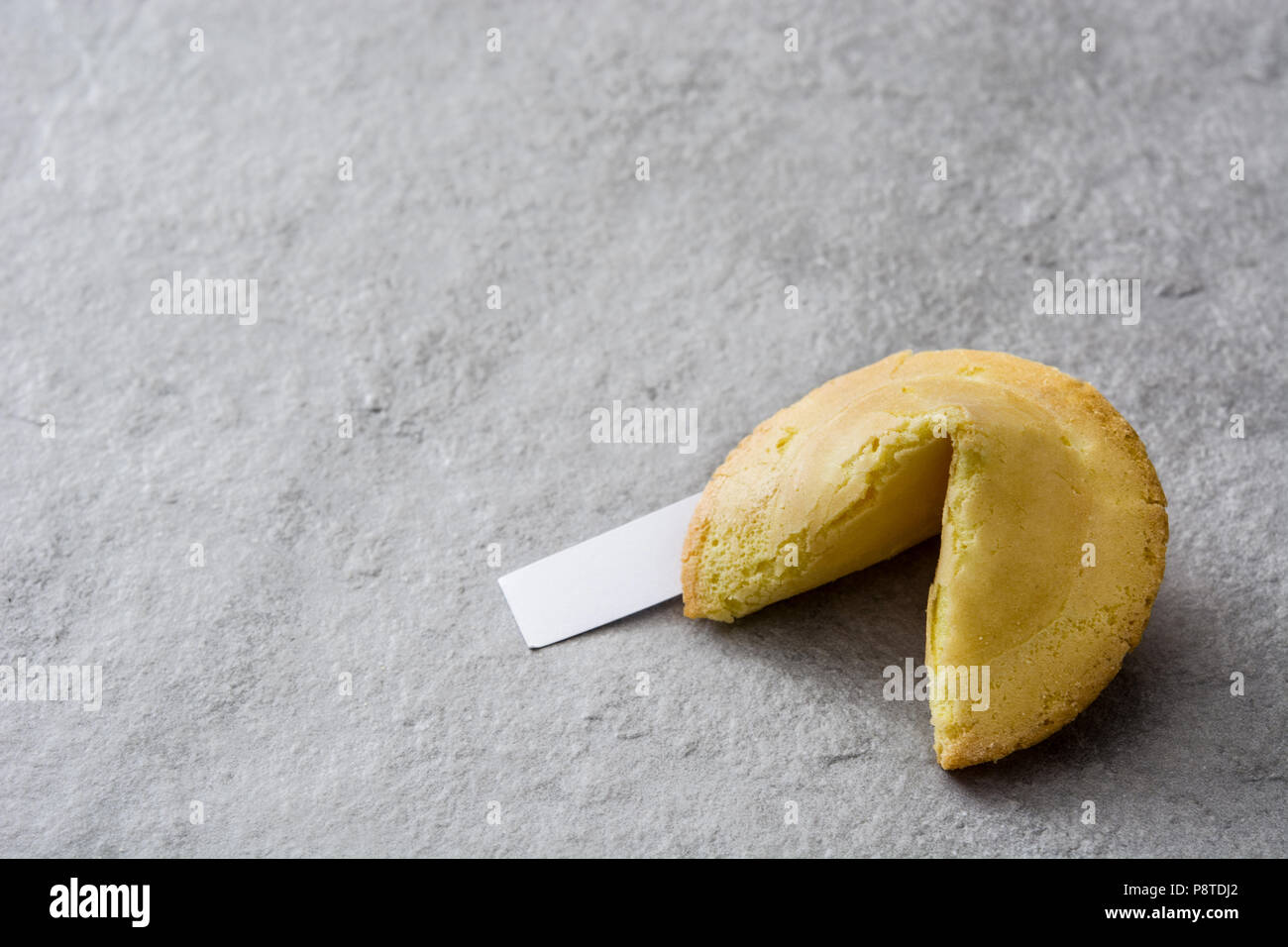 Fortune cookie on gray stone background. Copyspace Stock Photo