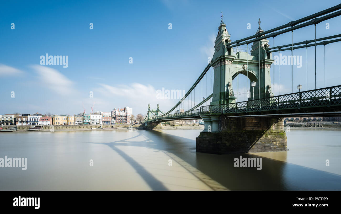 Long exposure landscape view of Hammersmith Bridge, London, looking towards Chiswick and riverside pubs Stock Photo