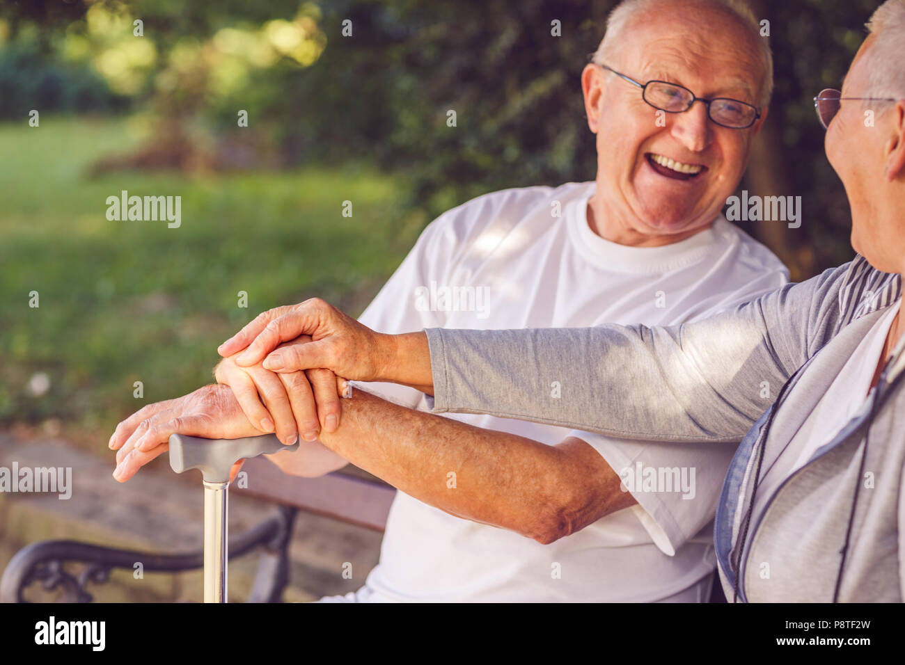 hands of senior couple - Elderly couple in the park smiling while feeling happy together concept Stock Photo