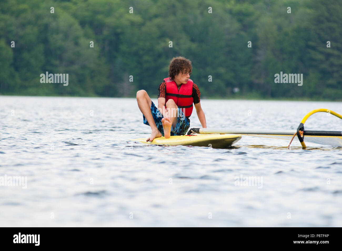 Teenage boy windsurfing on a lake in Ontario, canada Stock Photo Alamy
