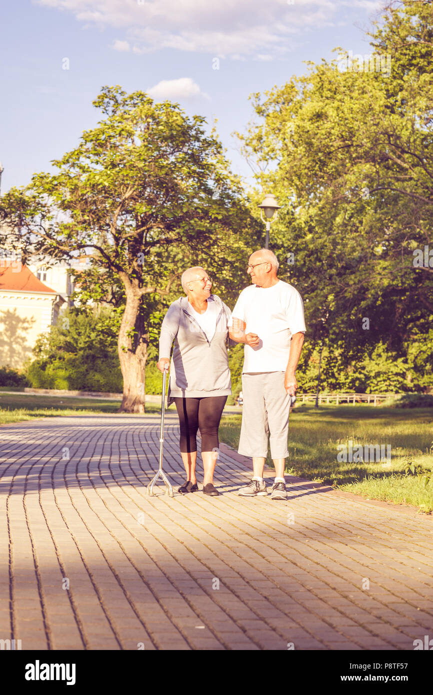 Happy family -Smiling senior couple walking through the park Stock Photo