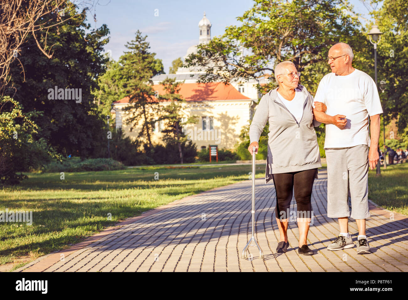 Happy Family - Smiling elderly couple walking through the park Stock Photo