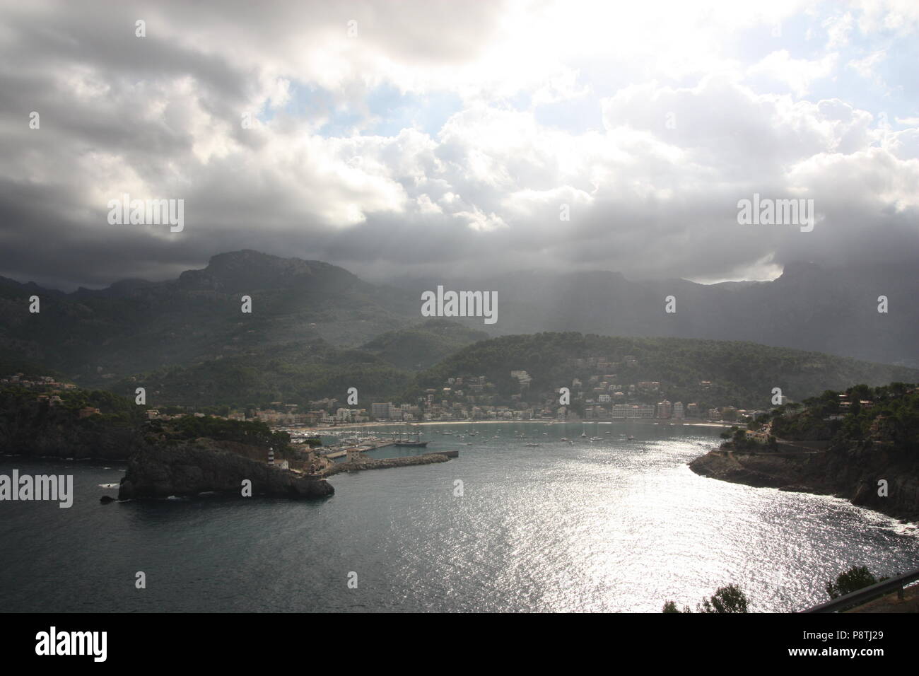 Sunrays through gap in clouds over Bay de Soller at Port de Soller in Majorca Stock Photo