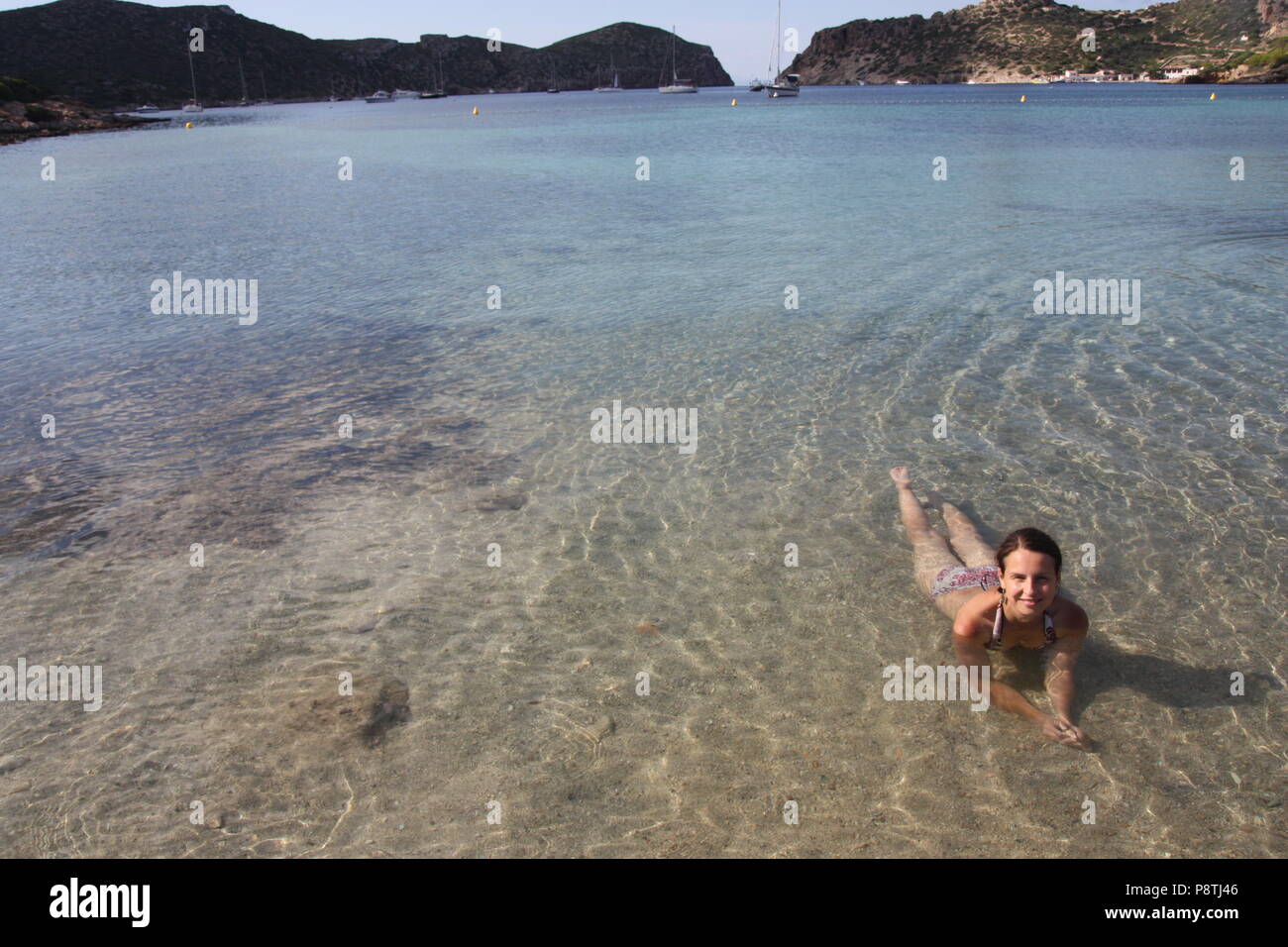 Beautiful woman smiling lying in the sea on Cabrera Islands Majorca in the Mediterranean Sea Stock Photo