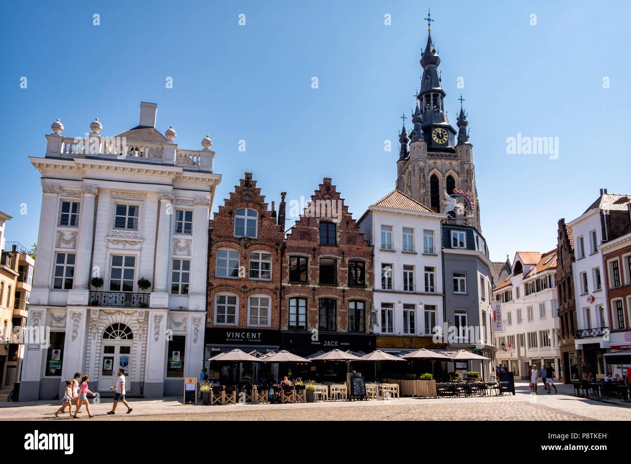 Kortrijk, Flanders, Belgium - JULY 1, 2018 : Some stepped gables at the Grote Markt square in the city center of Kortrijk, the St. Martin's church in  Stock Photo