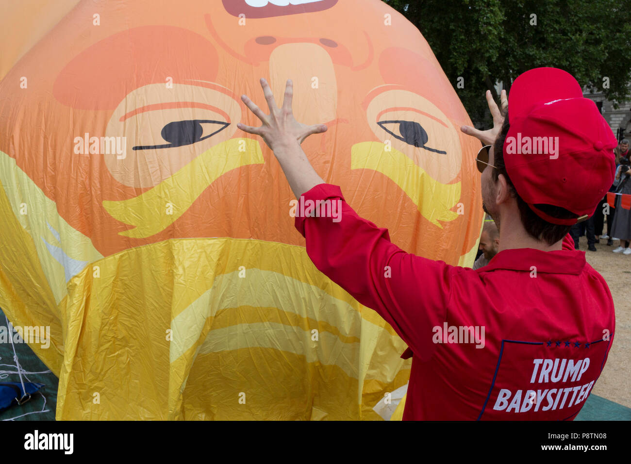 London, UK. 13th July, 2018. The inflatable balloon called Baby Trump is almost readt to fly above Parliament Square in Westminster, the seat of the UK Parliament, during the US President's visit to the UK. Baby Trump is a 20ft high orange blimp depicting the US President as an enraged, smartphone-clutching infant - and given special permission to appear above the capital by London Mayor Sadiq Khan because of its protest rather than artistic nature. It is the brainchild of Graphic designer Matt Bonner. Credit: RichardBaker/Alamy Live News Stock Photo