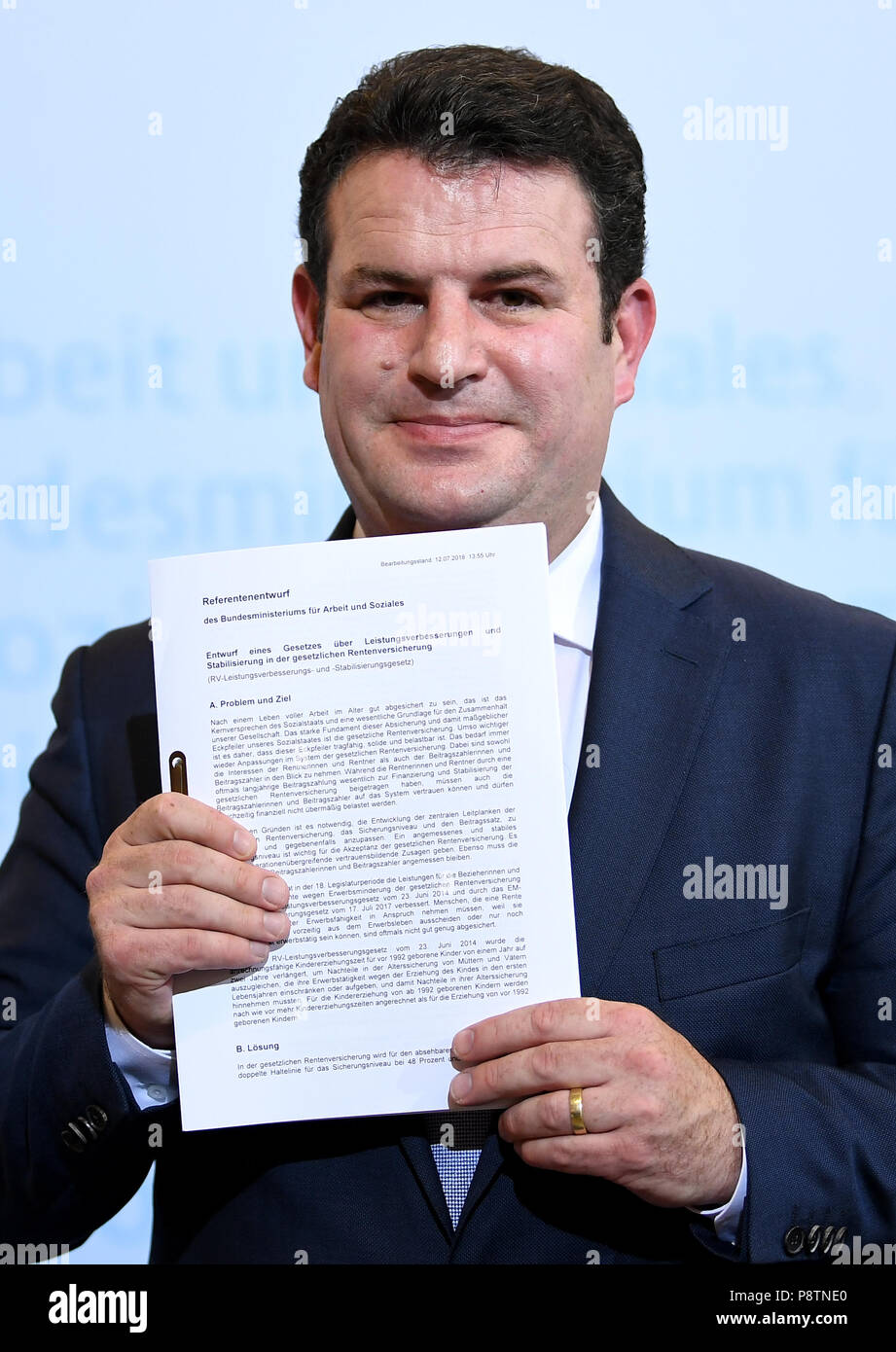 Berlin, Germany. 13th July, 2018. Minister for Work and Social Affairs from the Social Democratic Party (SPD), Hubertus Heil, giving a press conference for the outline of the new pension concept. He is holding his outline for a pension scheme in his hands. Credit: Britta Pedersen/dpa-Zentralbild/dpa/Alamy Live News Stock Photo