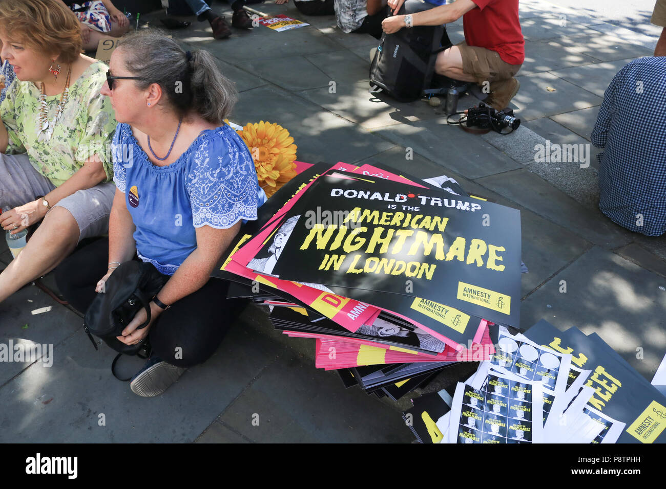 London UK. 13th July 2018.  Protesters holding placards  demonstrate  against the UK visit  of President Donald Trump as tens of thousands of protesters are expected to march to voice their displeasure against  the controversial policies of President Trump on immigration, climate change and Islamophobia. Trump dealt a double blow to U.K. Prime Minister Theresa May,criticising her plans for a soft Brexit would likely end hopes of a trade deal with the U.S. and that Boris Johnson, who quit her cabinet this week, would be a 'great' leader Credit: amer ghazzal/Alamy Live News Stock Photo