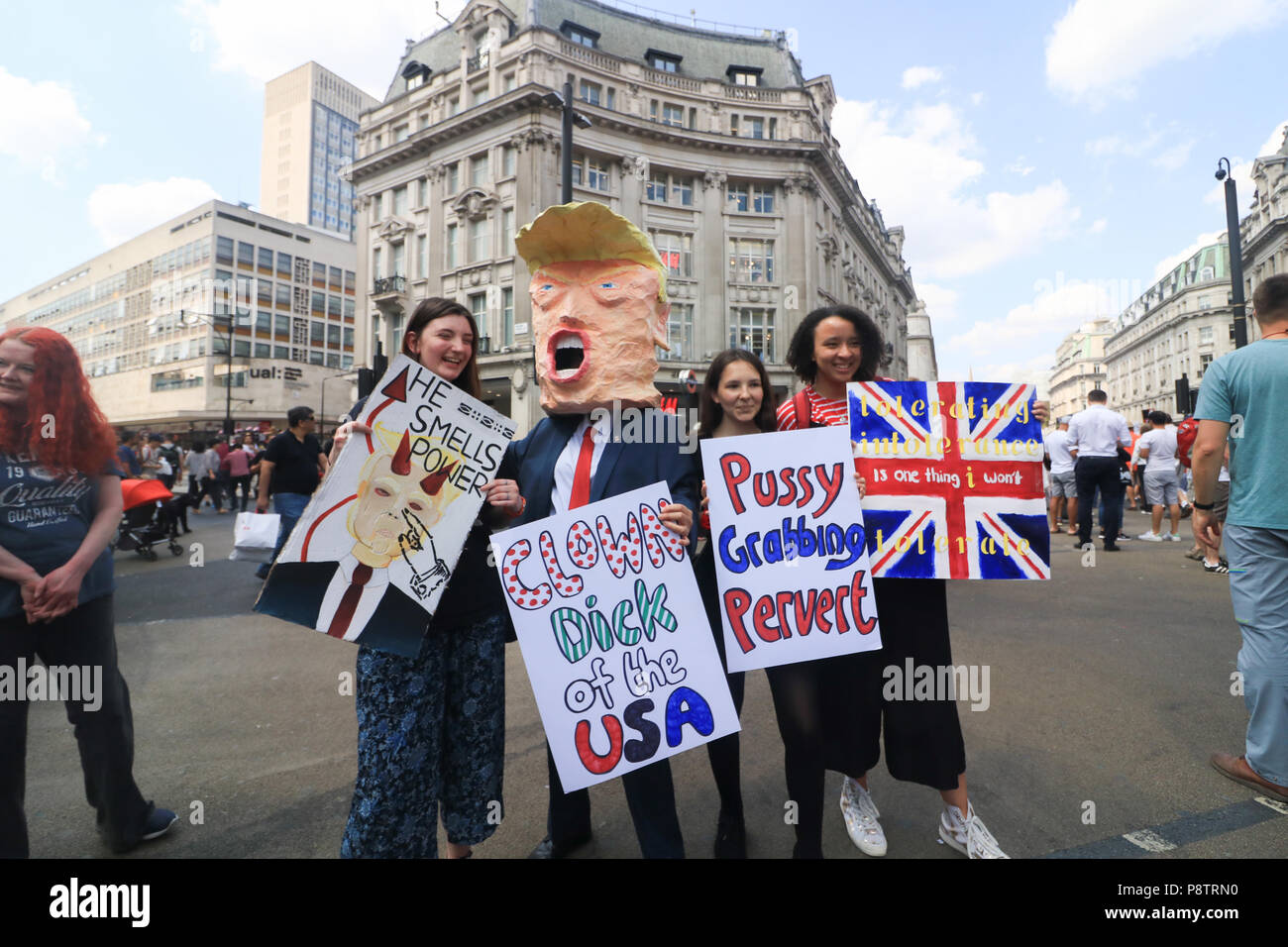 London UK. 13th July 2018.  Protesters holding placards  demonstrate  against the UK visit  of President Donald Trump as tens of thousands of protesters are expected to march to voice their displeasure against  the controversial policies of President Trump on immigration, climate change and Islamophobia. Trump dealt a double blow to U.K. Prime Minister Theresa May,criticising her plans for a soft Brexit would likely end hopes of a trade deal with the U.S. and that Boris Johnson, who quit her cabinet this week, would be a 'great' leader Credit: amer ghazzal/Alamy Live News Stock Photo