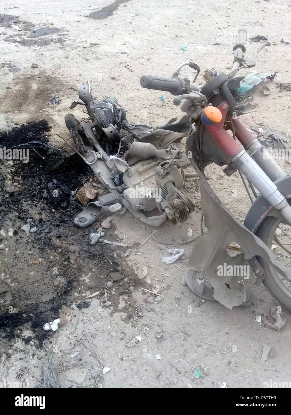 Bannu. 13th July, 2018. A damaged motorcycle is seen at the blast site in northwest Pakistan's Bannu on July 13, 2018. At least four people were killed and 24 others injured when a blast hit a convoy of a political party leader in Pakistan's northwest Khyber Pakhtunkhwa province on Friday, local reports said. Credit: Stringer/Xinhua/Alamy Live News Stock Photo