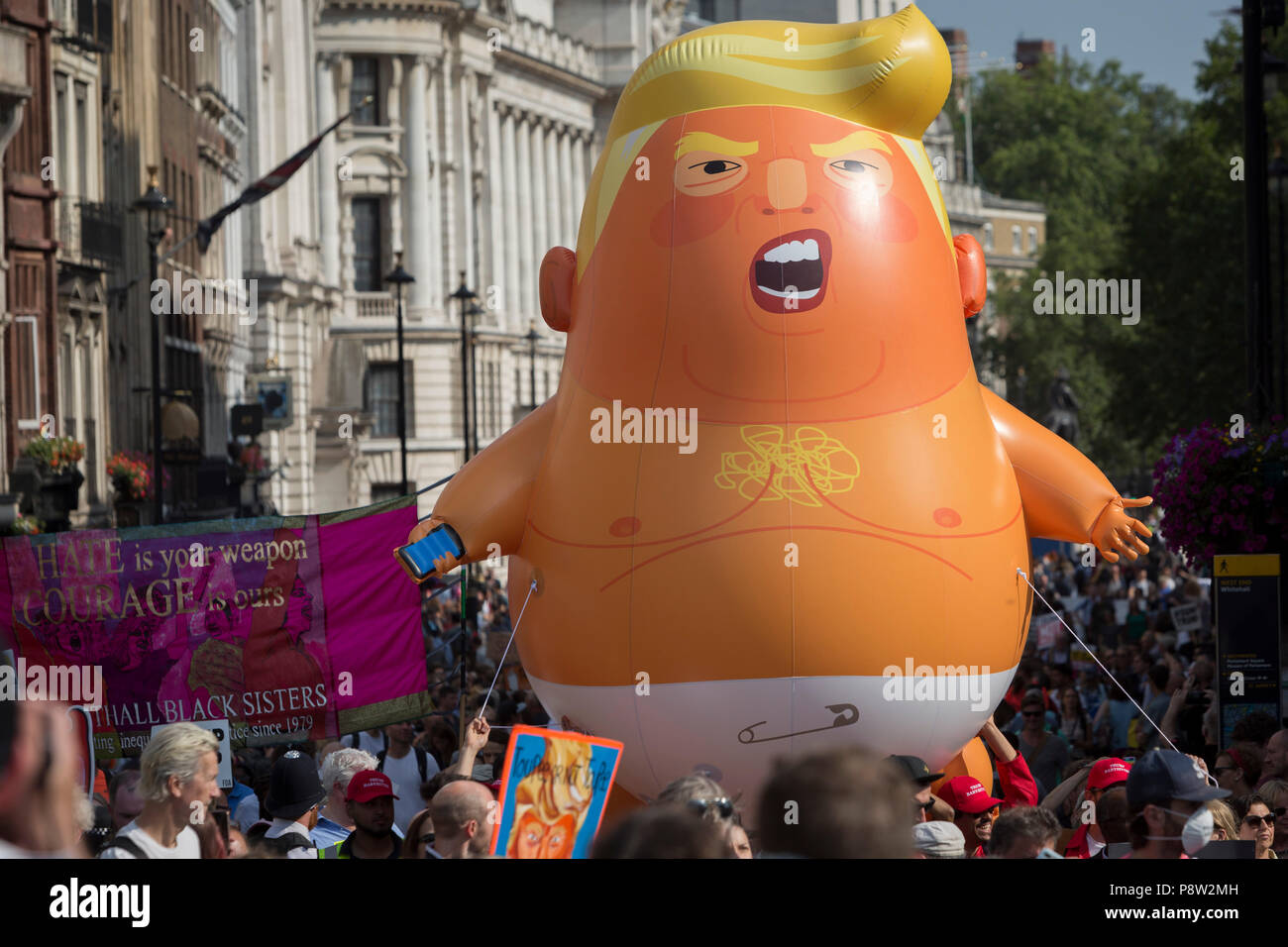London, UK: The Baby Trump balloon joins protesters against the visit of US President Donald Trump to the UK, march through central London, on 13th July 2018, in London, England. Photo by Richard Baker / Alamy Live News Stock Photo