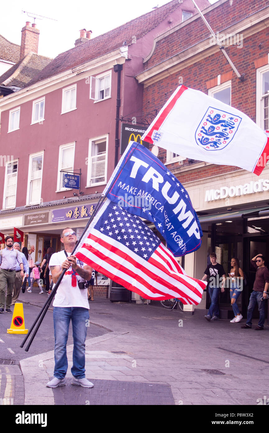 A Trump supporter holds the Stars and Stripes flag, and the Three lions flag during a demonstration against presidents visit to the UK. UK  Bridget Catterall Windsor, UK Alamy Live News UK Stock Photo