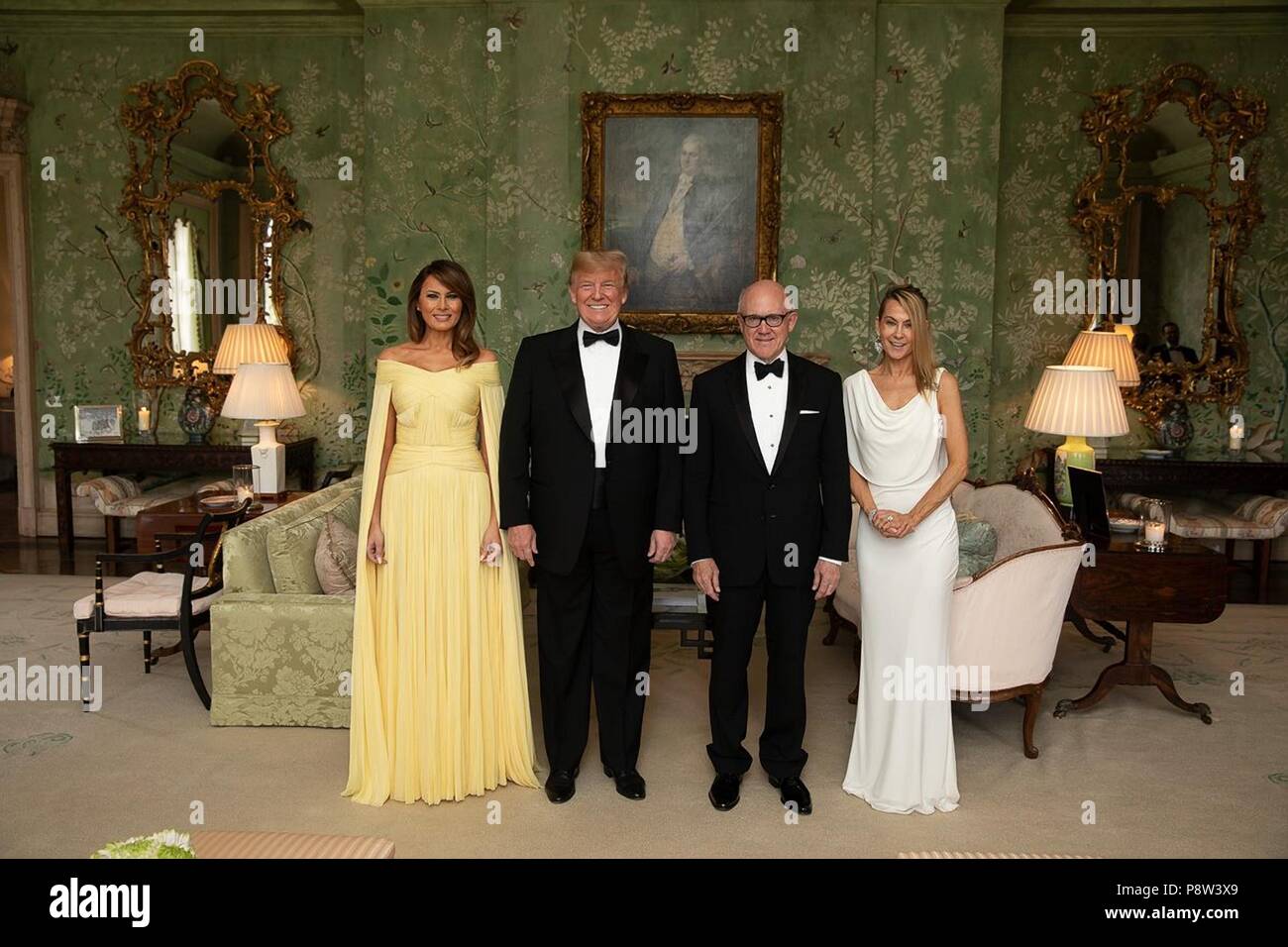 London, UK, 13 July 2018. U.S President Donald Trump and First Lady Melania Trump stand with American Ambassador to the United Kingdom Woody Johnson and his wife Suzanne Ircha at Winfield House prior to departing for dinner at Blenheim Palace hosted by Prime Minister Theresa May and Philip May July 12, 2018 in London, England. Credit: Planetpix/Alamy Live News Stock Photo