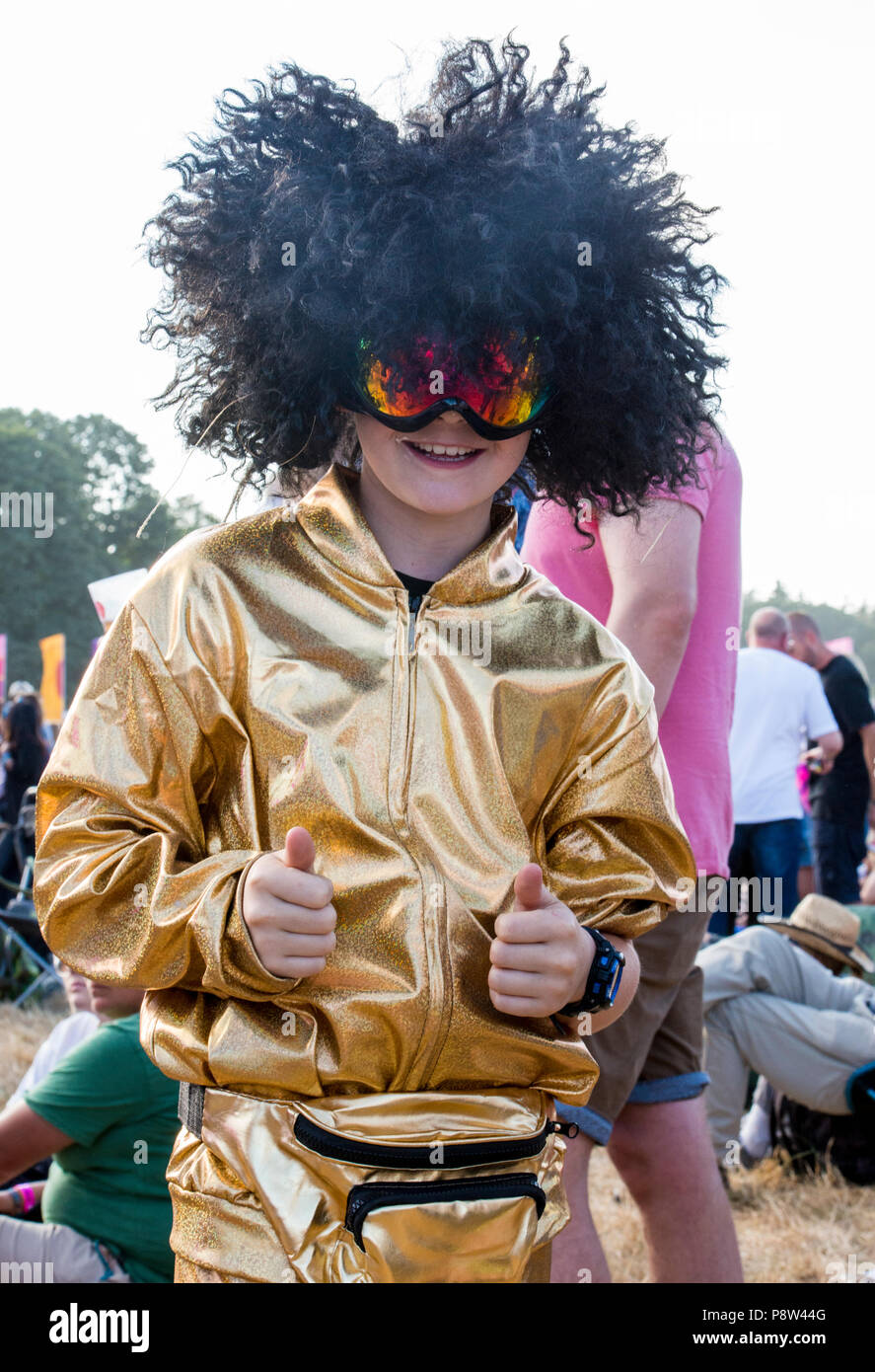 Portrait of a young festival goer enjoying the music wearing fancy dress with wig, at the Obelisk Stage at Latitude Festival, Henham Park, Suffolk, England, 13 July 2018. Stock Photo
