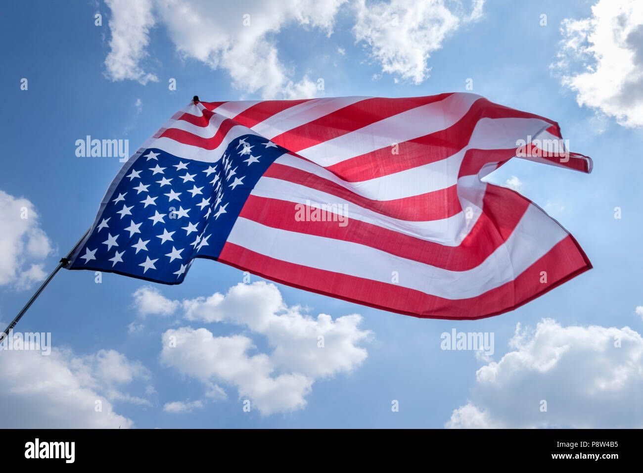 London, UK. 13th July 2018. Tens of thousands of people took to the streets of central London to protest against US President Donald Trump's visit to the UK. Pictured: An inverted Stars and Stripes flag waves in the sky. Credit: mark phillips/Alamy Live News Stock Photo