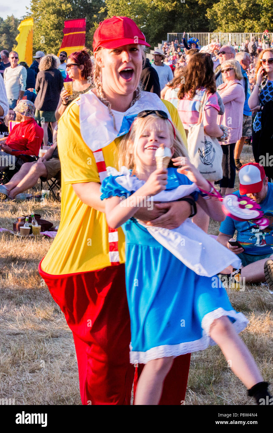 Portrait of mother and daughter, wearing fancy dress, enjoying the atmosphere at the Obelisk Stage at Latitude Festival, Henham Park, Suffolk, England, 13 July 2018. Stock Photo