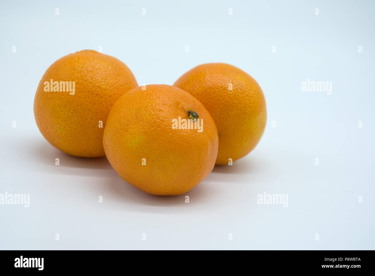 three satsuma oranges on a white background Stock Photo Alamy