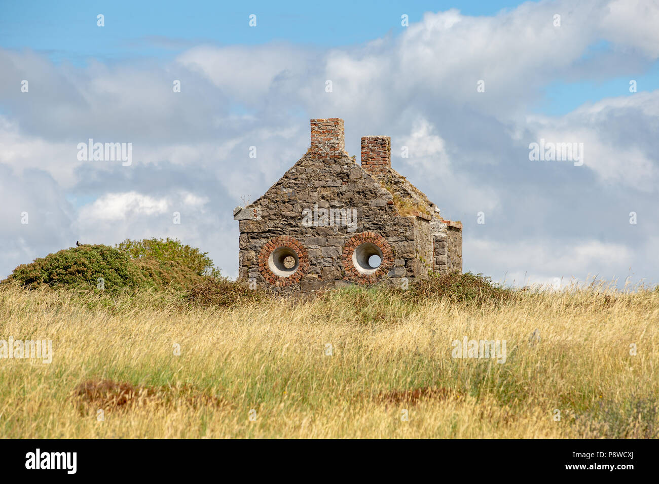 In ruins the Old Watchhouse with circle windows at the Rosses Point used by Sligo River Pilots to watch for sailing ships. Stock Photo