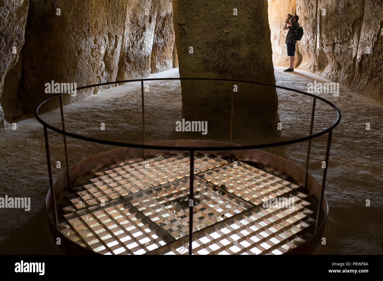 Antequera, Spain - July 10th, 2018: Visitor takes pictures at interior chamber of Dolmen of Menga, Antequera, Spain Stock Photo