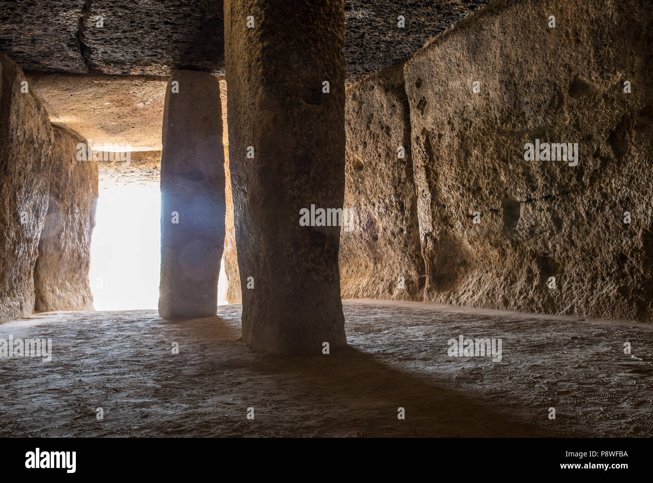 Antequera, Spain - July 10th, 2018: Dolmen of Menga chamber, Antequera. Sun rays entering at corridor Stock Photo