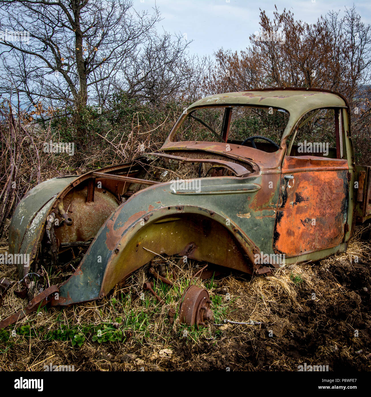 Old truck carcass rusty and boned amidst fields in winter, Auvergne, France, Europe Stock Photo