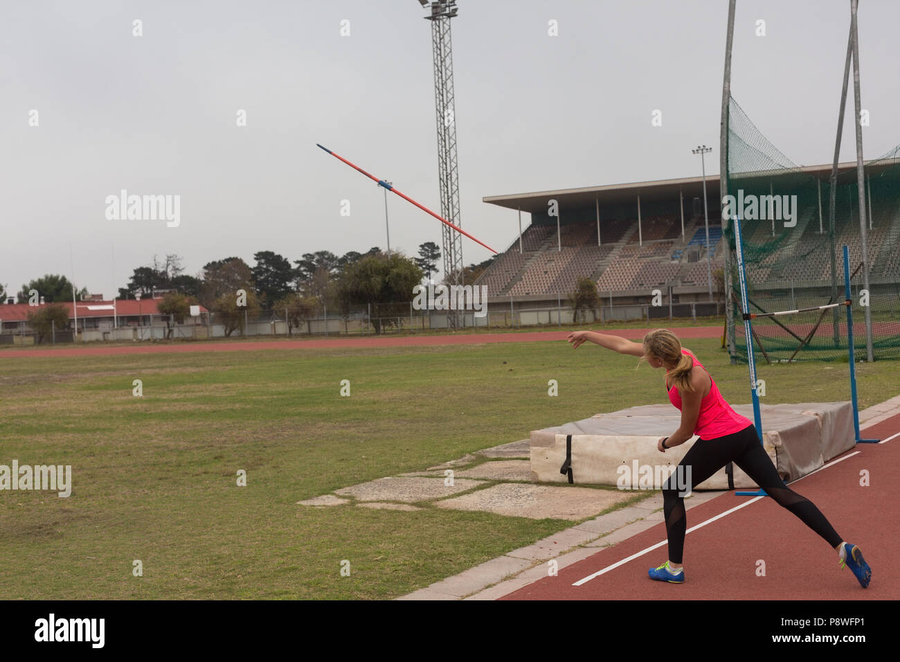 Female athlete practicing javelin throw Stock Photo