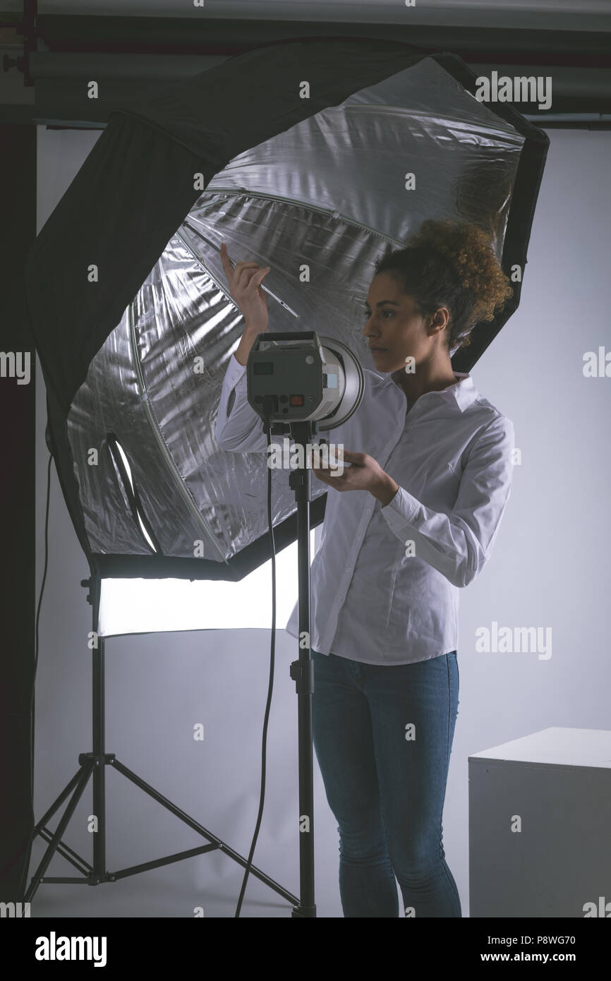 Female photographer adjusting strobe lights Stock Photo Alamy