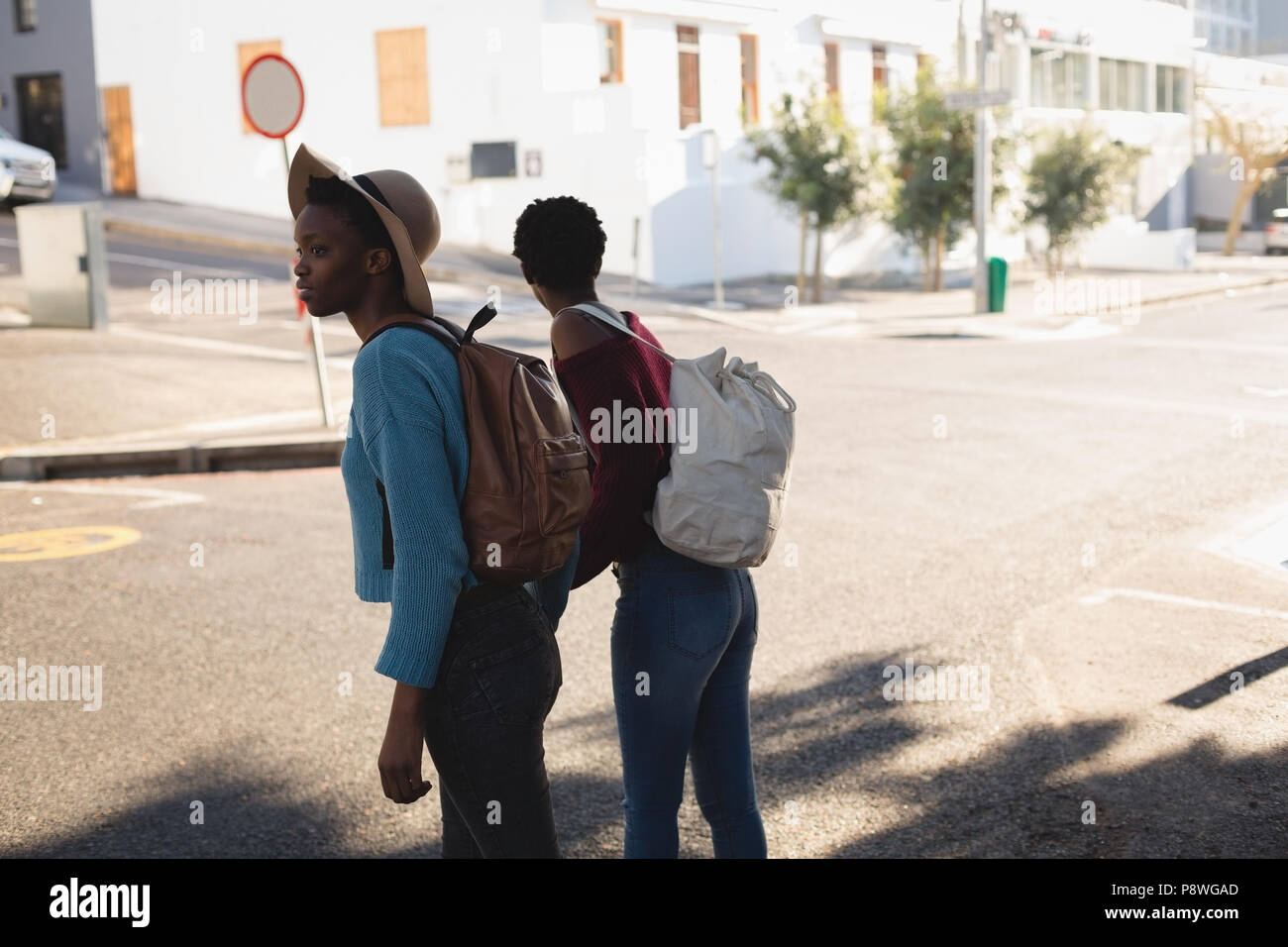 Twins siblings standing with backpack Stock Photo Alamy