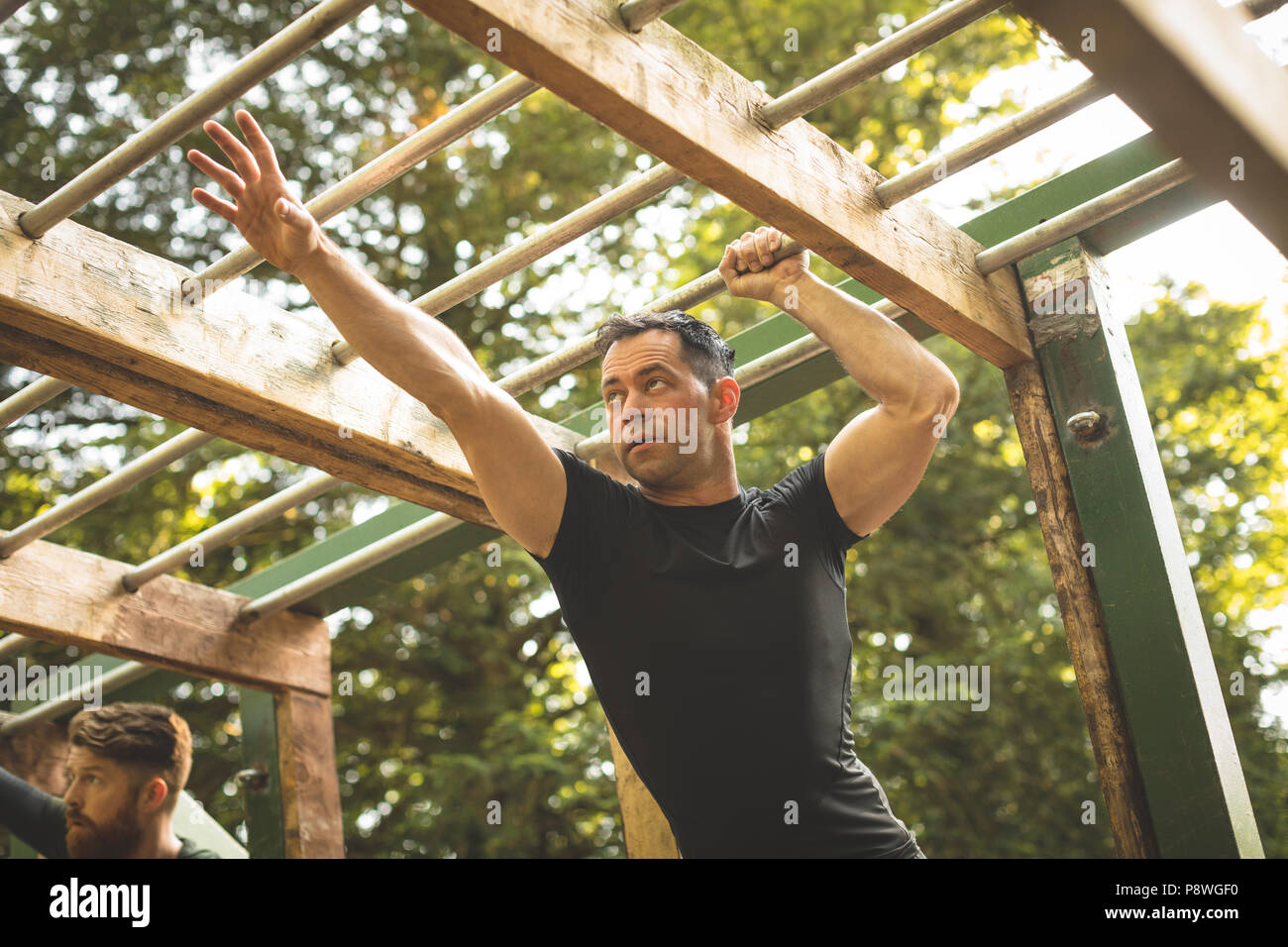 Fit man climbing monkey bars Stock Photo Alamy