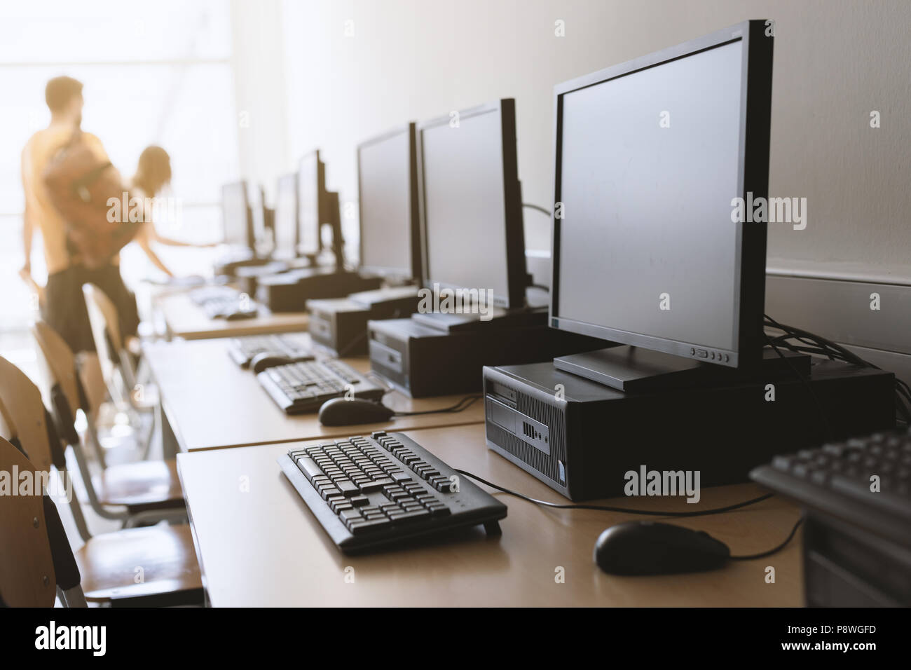 Row of desktop computers in classroom setting Stock Photo Alamy